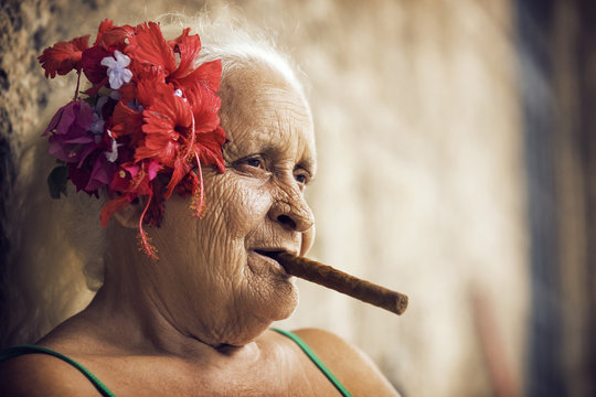 Close up of senior woman smoking cigar