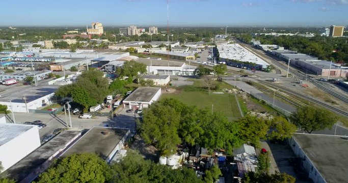 Stock drone footage of a warehouse district with railroad tracks