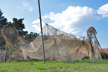 Fishing nets are hung up for drying on the sun