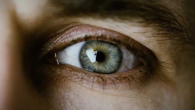 Close-up of a Blinking Man's Eyes. It's Grey with Brown Dots. Shot in Cold colours. Shot on RED EPIC-W 8K Helium Cinema Camera.