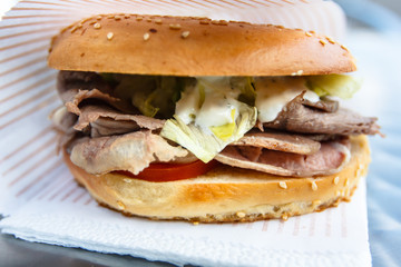 Bagel, or a Burger with grilled meats, tomato and lettuce.