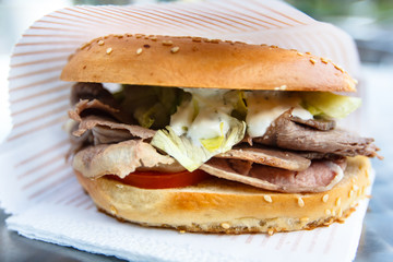 Bagel, or a Burger with grilled meats, tomato and lettuce.