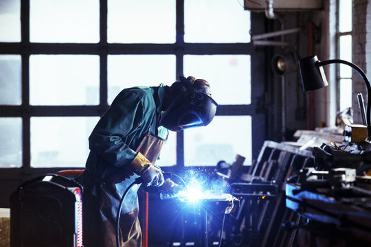 Welder working in workshop