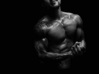 Strong athletic man showes naked muscular body