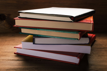 Stack of books on the wooden table