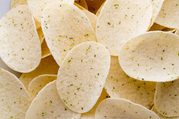 Close up potato chips on wood top view background.