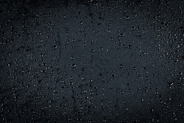 Water drops on dark stone