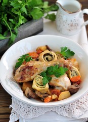 Chicken stew with vegetables, potatoes, carrots, mushrooms, onions and rolls with dill and green onions.