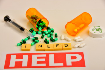 Pills, capsules, containers and signs to symbolize prescription medication abuse.