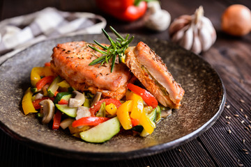 Fried pork steaks stuffed with cheese, pickles, mustard and served with stewed vegetable
