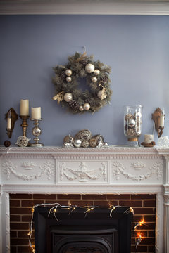 Christmas wreaths hanging on wall over fireplace