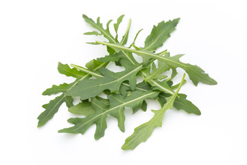 Close up studio shot of green fresh rucola isolated on white bac