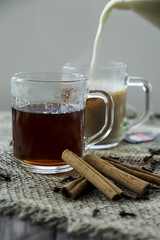 Masala tea with milk and spices - cinnamon, cloves, pepper, cardamom and ginger