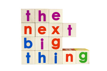 THE NEXT BIG THING concept spelled with colorful toy blocks. Isolated.
