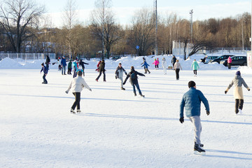 Unidentified people skating on the outdoors ice rink, Petrozavodsk, Russia - obrazy, fototapety, plakaty