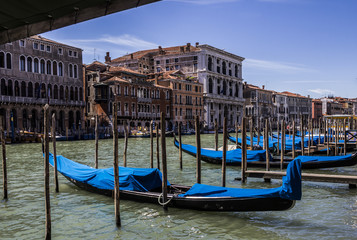 Fototapeta na wymiar Grand Canal at one summer day, mooring gondolas at berthes, Venice, Italy