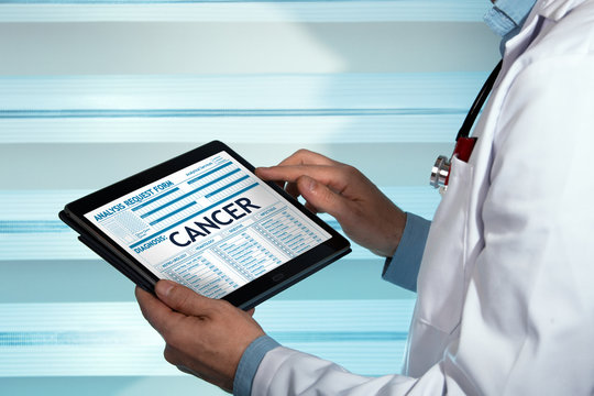 Doctor with a cancer diagnosis in digital medical report / physician consulting on tablet medical report on the internet