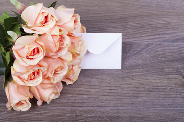 Beautiful roses with a note in the envelope