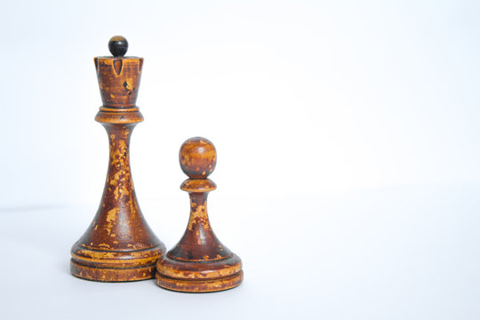 Old chess Board with wooden pieces on a white background.