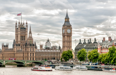London - view of Big Ben clock tower, Houses of Parliament and Thames river with boats, United Kingdom.