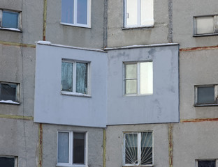 Fototapeta premium A fragment of a multi-storey concrete panel residential building with an externally applied external insulation on the facade of the apartment