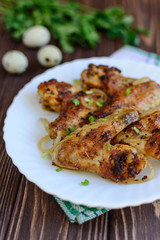 Chicken wings with onion on wooden background