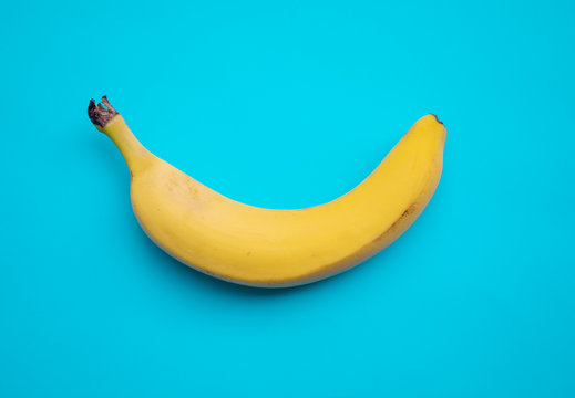 banana on blue pastel background. minimal concept.