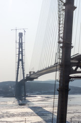 Fototapeta premium The construction of the cable-stayed bridge across the bay in the Pacific Ocean