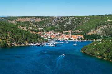 Fototapeta na wymiar Town of Skradin on Krka river in Dalmatia, Croatia viewed from distance. Skradin is a small historic town and harbour