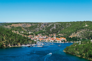 Obraz na płótnie Canvas Town of Skradin on Krka river in Dalmatia, Croatia viewed from distance. Skradin is a small historic town and harbour