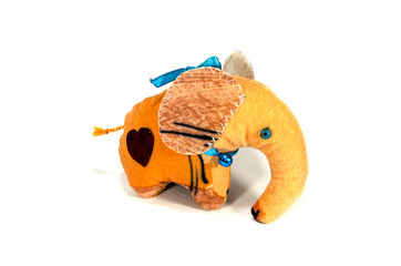 Orange toy elephant with a heart and a bell. Gift. Handmade