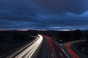 Night View of Highway Traffic and Cloudy Sky