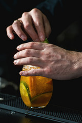 bartender making refreshing coctail with cucumber isolated on a bar background