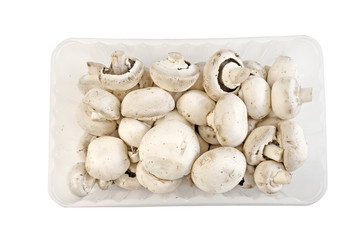 Plastic box with fresh white mushrooms