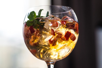 refreshing coctail with strawberries isolated on a bar background