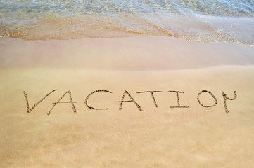 vacation note written on the beach - sand note summer concept