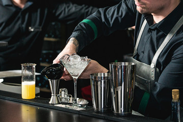 bartender making relaxing coctail on a bar background