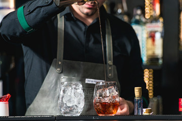 bartender making relaxing coctail on a bar background