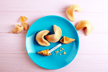 Plate with fortune cookies  on wooden background
