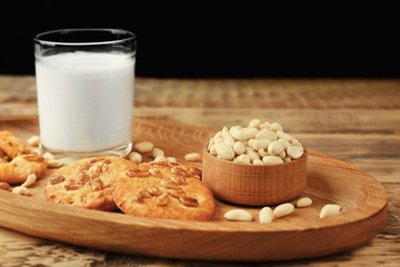 Peanut cookies with milk on tray on table
