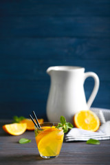 Glass of fresh lemonade on table