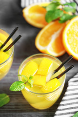 Glass with fresh lemonade on wooden background