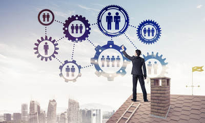 Businessman on house roof presenting teamwork and connection con