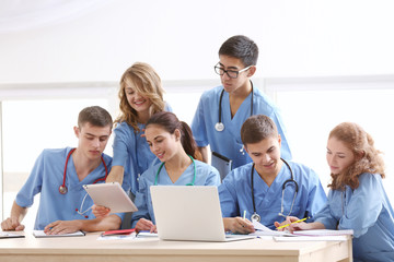 Group of medical students having lecture indoors