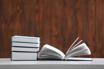 Pile of books on table and wooden background