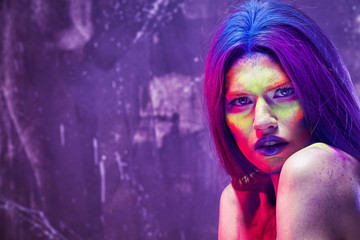 Portrait of beautiful young woman with amazing body-art on color background