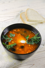 delicious saltwort soup in a black bowl and bread