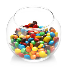 Colorful candies in glass vase on white background
