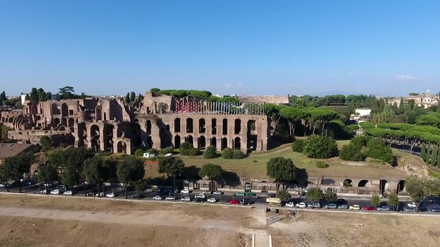 Aerial bird view Italy Rome flying over Domus Severiana moving lower altitude to left extension to imperial palaces Palatine Hill in Roma popular tourist attraction in large and beautiful city center
