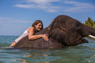 Girl swims with the elephant